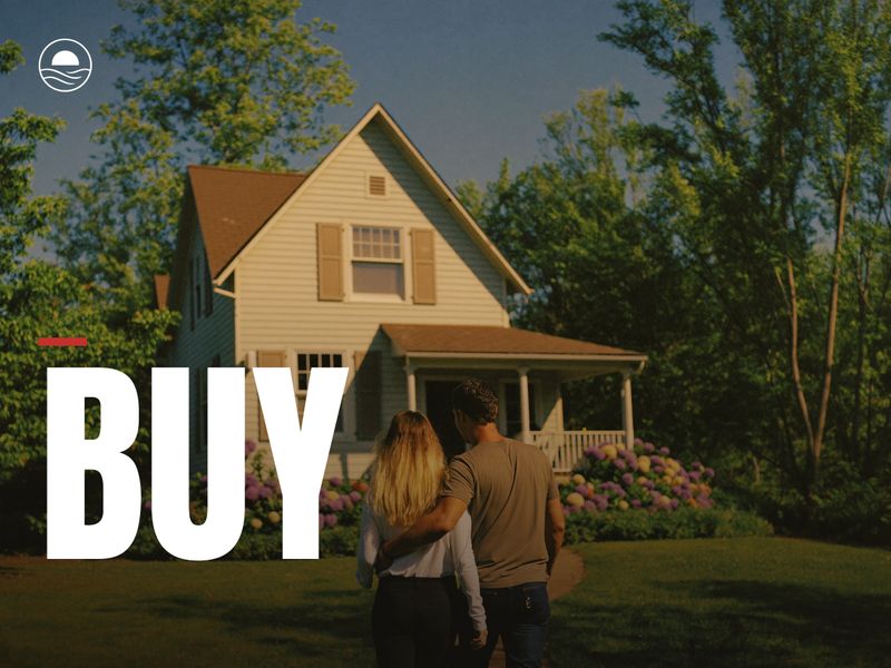 BUY: a couple arm in arm looking at a house on a sunny afternoon